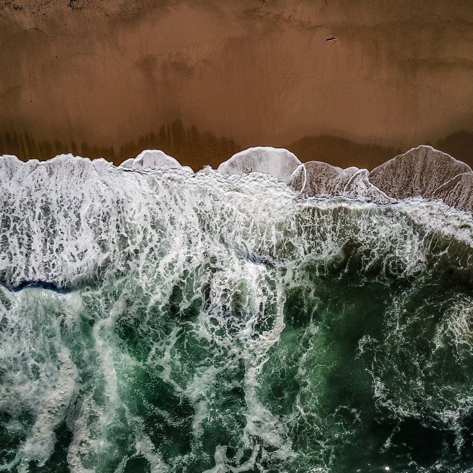 ocean waves meet red sands