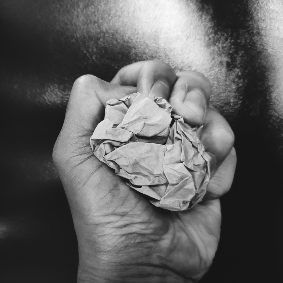 Crumpled paper in the hand, concept pressure, stress and anger