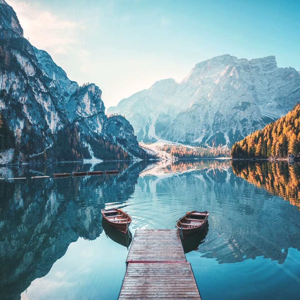 Boats on the Braies Lake ( Pragser Wildsee ) in Dolomites mountains, Sudtirol, Italy