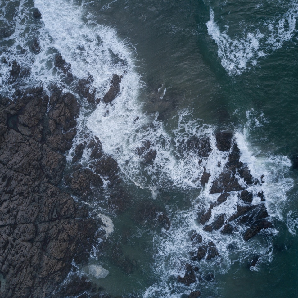 Aerial photo of small waves breaking. Taken off the coast of a small surf town in beautiful New Zealand.