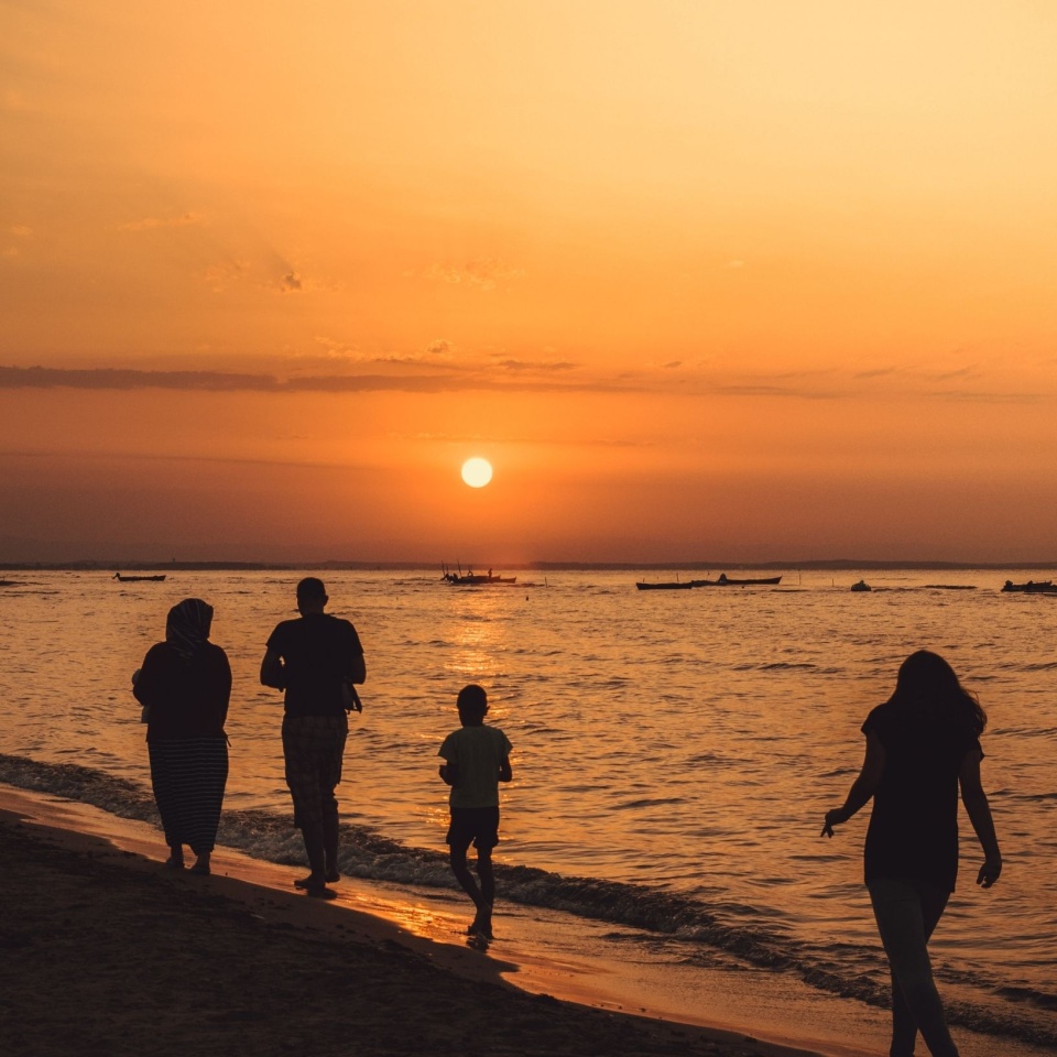 happy family on the beach walking
