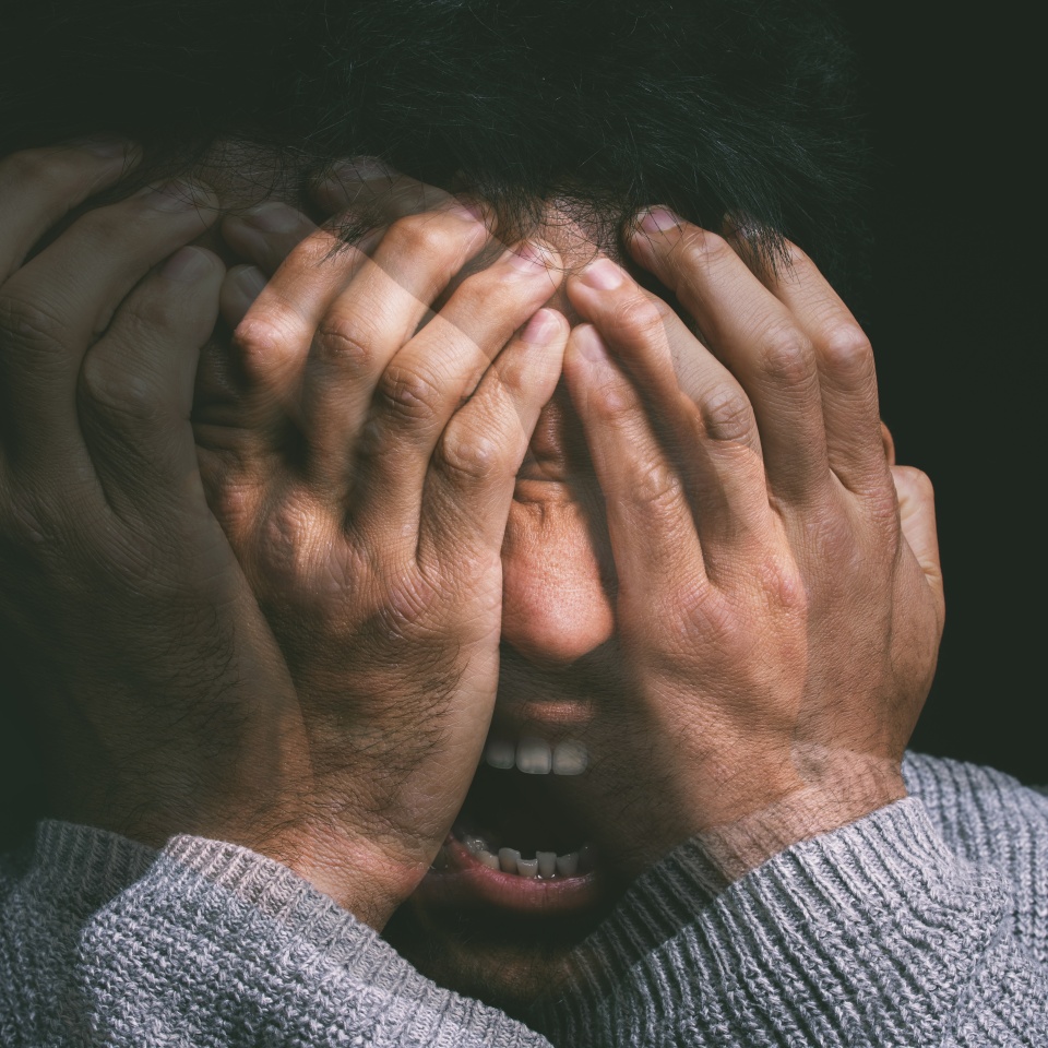 When your mind is your own worst enemy. Studio shot of a young man experiencing mental anguish and screaming against a black background.