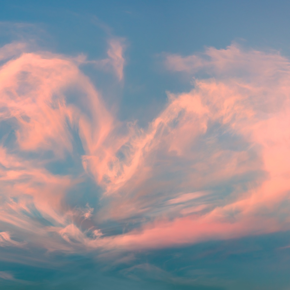 Magic real heart made from clouds in the sunset sky. Pink light heart shaped clouds. Love. Panoramic sky for Valentine's Day, Wedding, Mother's Day. Holidays of love and tenderness
