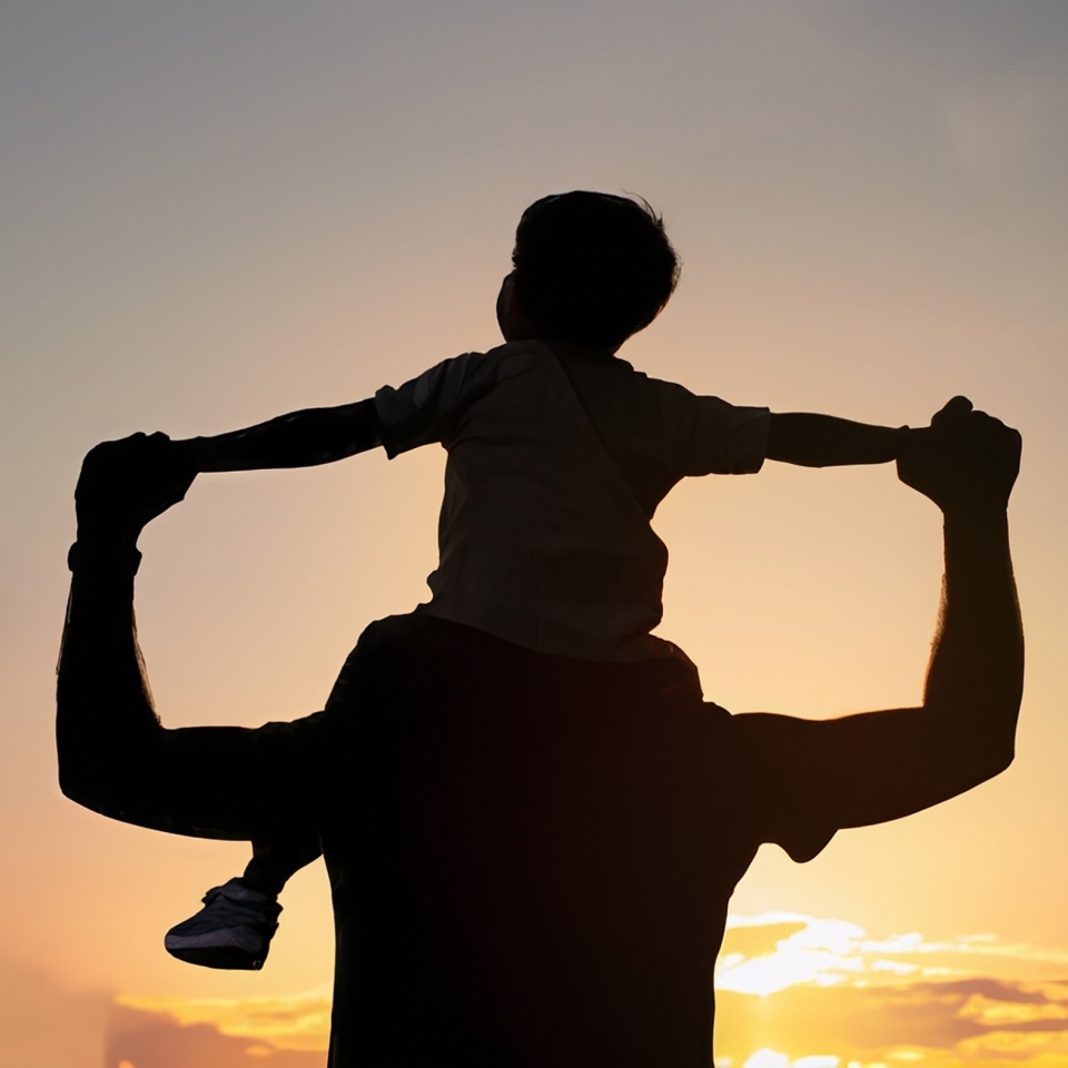 silhouette with sunset view, happy father carrying his son on his back