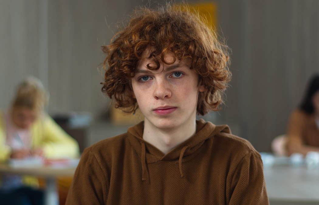 High school university teenager education study calm smiling peaceful serious Caucasian guy boy pupil teen male man schoolboy student studying learning college looking at camera class lesson portrait