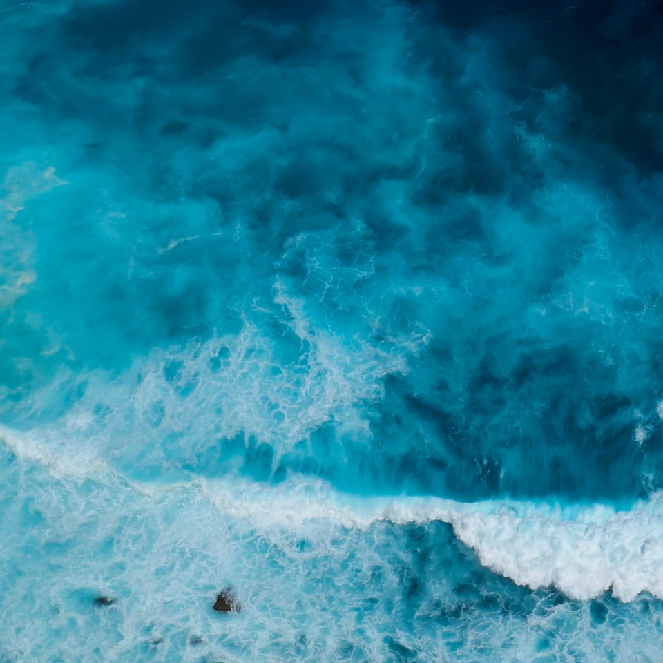 Turquoise ocean sea water white wave splashing deep blue sea. Bird eye view monster wave splash on rock. Tropical sea beach in summer seaside outdoor. Ocean island beautiful dramatic landscape.