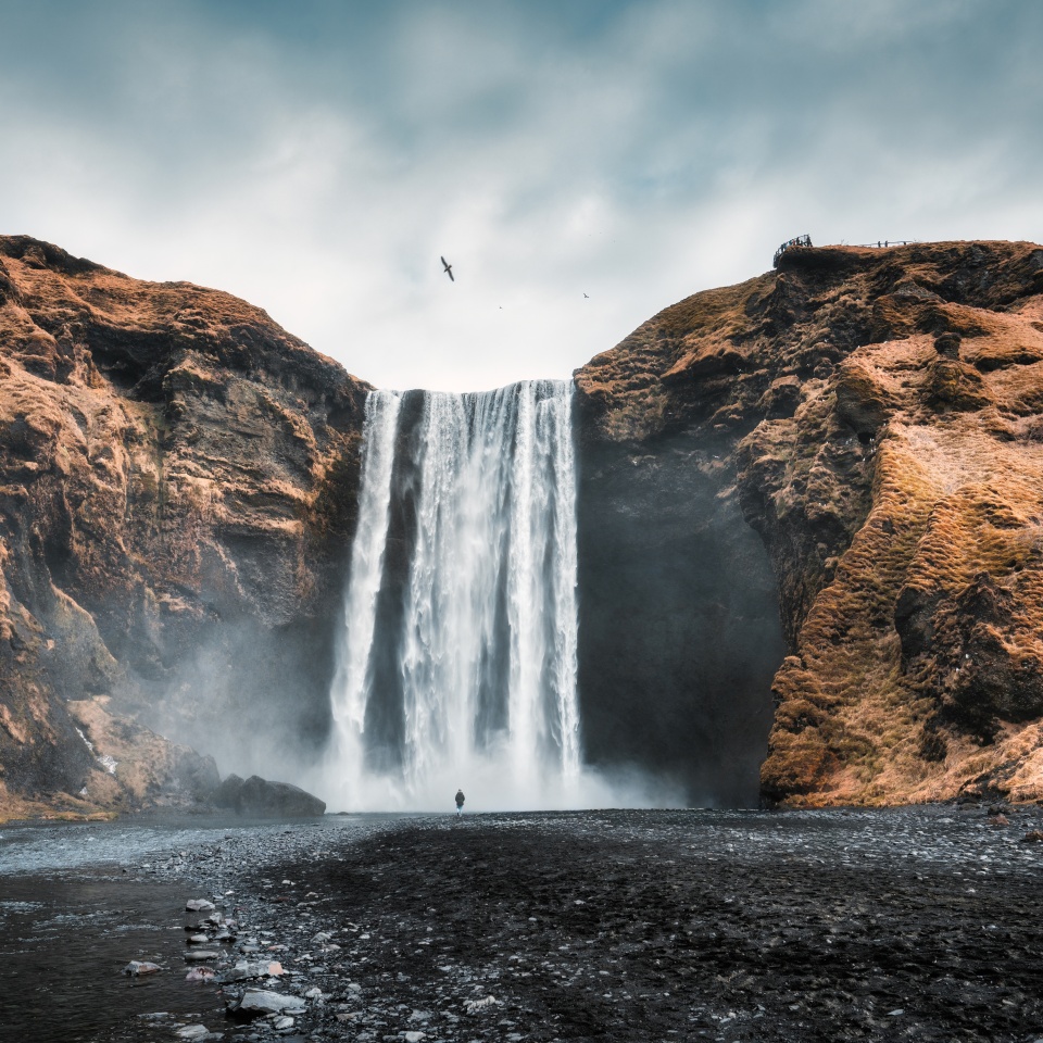Dramatic landscape of powerful Skogafoss waterfall flowing from volcanic mountain in autumn at South of Iceland