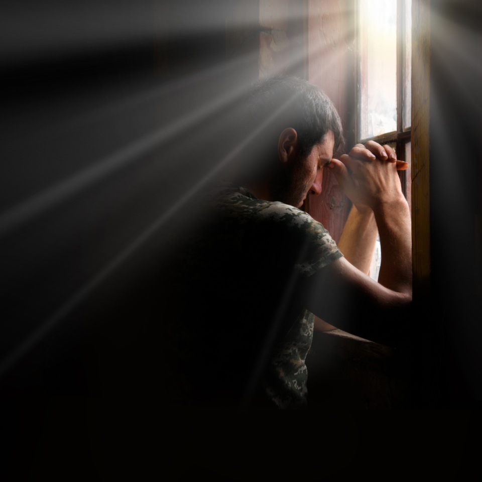Tired pensive devote belief navy force young guy hero face cry hope hand pain love dark black old retro home room sun light text space Worry human feel lost despair frown upset warfare believe concept