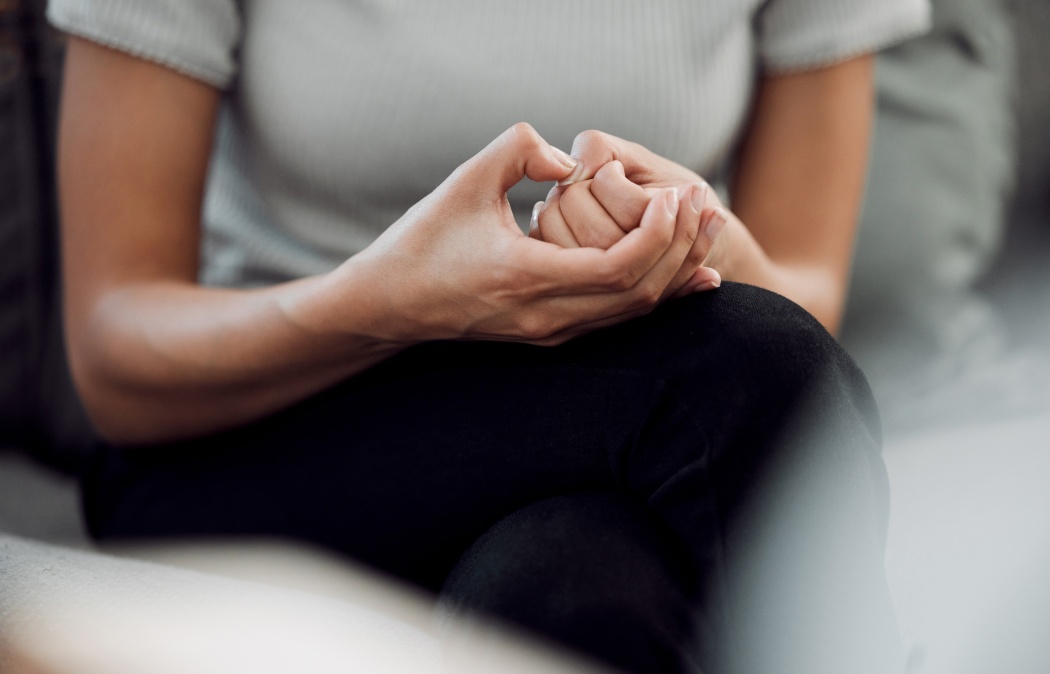 A common sign of anxiety is subconscious skin picking. Cropped shot of an unrecognisable woman sitting alone and feeling anxious while picking the skin on her nails